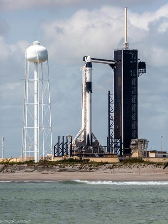 Close-up photo of the SpaceX Falcon 9 rocket with the Crew Dragon capsule on its pad LC-39A, taken on a Star Fleet boat tour